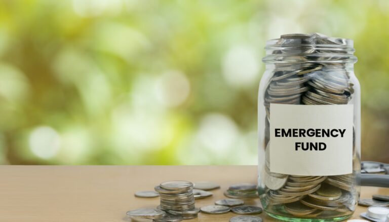 Person saving money for emergency fund with coins and calculator, representing financial preparedness and budgeting for unexpected expenses.