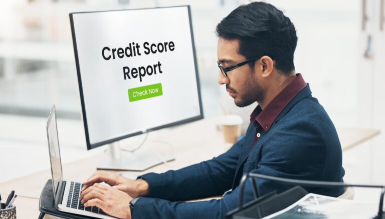 An image of a person using a laptop to check their credit report, with a clear view of their credit score displayed on the screen, symbolizing financial awareness and responsibility.